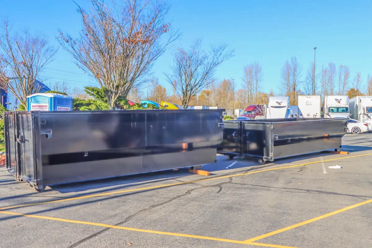 Professional dumpster rental service with roll-off container on residential driveway in North Reading